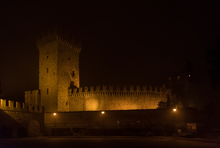 Night view of a medieval castle in italyの写真素材