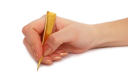 Female hand with gold pen writing on the white backgroundの写真素材