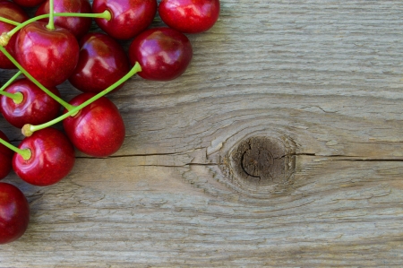 Group of Fresh Ripe Red Sweet Cherries on Wooden Background. Closeup. Space for Textの写真素材