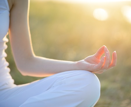 Young Beautiful Woman Practices Yoga on the Sunny Meadow. Active Lifestyleの写真素材