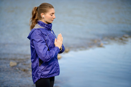 Young Beautiful Woman Meditate on the River. Active Lifestyleの写真素材