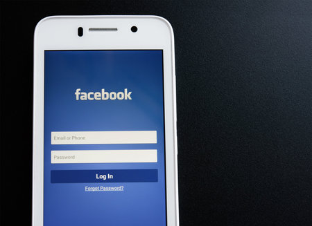 ZAPORIZHZHYA, UKRAINE - NOVEMBER 07, 2014: White Smart Phone with Facebook Social Network Log In...