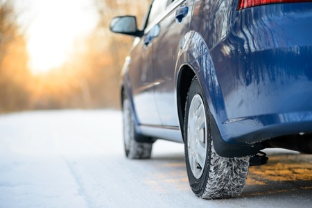 Close-up Image of Winter Car Tire on the Snowy Road. Drive Safe Concept.の写真素材
