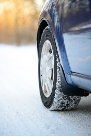 Close-up Image of Winter Car Tire on the Snowy Road. Drive Safe Concept.の写真素材