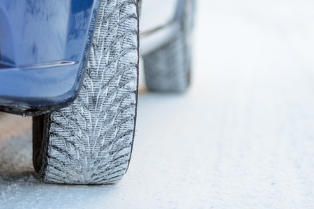 Close-up Image of Winter Car Tire on the Snowy Road. Drive Safe Concept.の写真素材