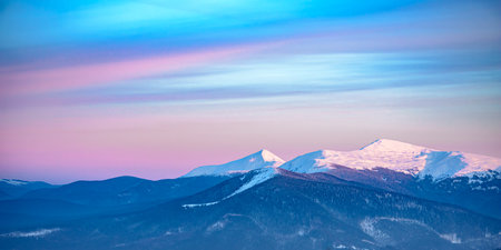 Beautiful Carpathian Mountains in Fog. Panorama of Winter Sunset over Mountain Landscape.の写真素材