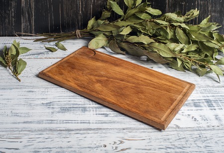 Empty vintage cutting board on planks food background concept black whiteの写真素材