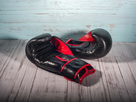 boxing gloves on blue and white cracked wooden background, empty spaceの写真素材