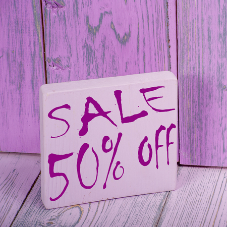 The inscription sale on a wooden background.の写真素材