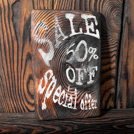 The inscription sale on a wooden background.の写真素材