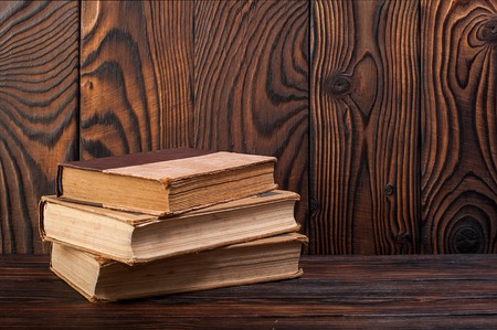Old books on a wooden backgroundの写真素材
