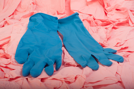 A lot of pink latex medical rubber gloves close upの写真素材