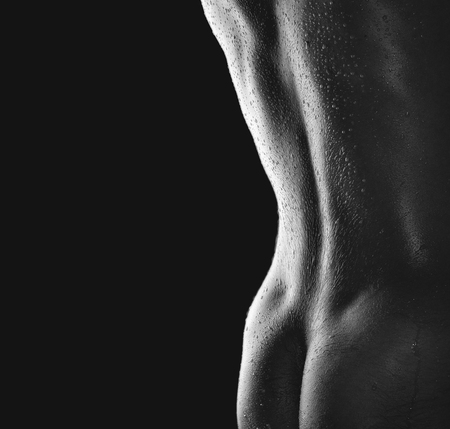 The back and buttocks of young athletic guyの写真素材