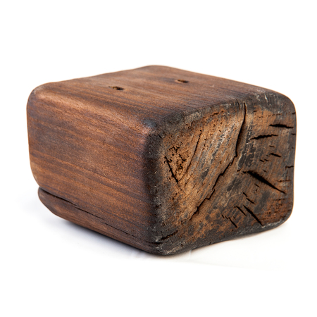 Big old dark cube is cut out from old wood. Isolated on whiteの写真素材