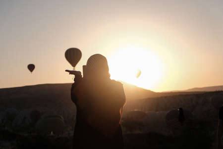 silhouette of a girl holding a balloonの写真素材