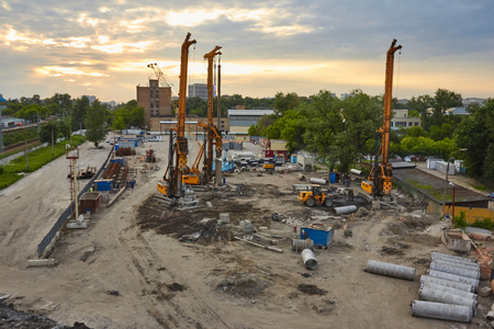 People work at the construction site at sunsetの写真素材