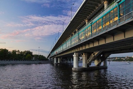 Metro bridge, combined with the road over the river at duskの写真素材