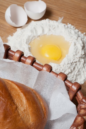 Bread and flour with egg on the wood tableの写真素材