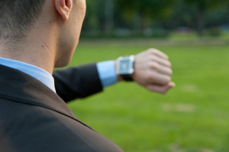Man checking the time in the park