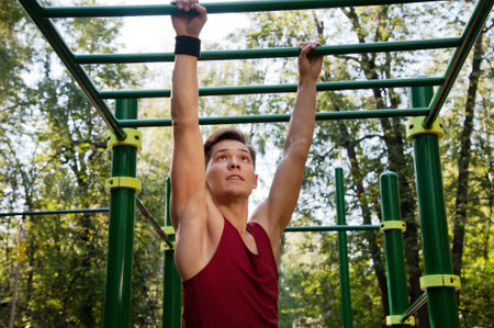 Young man doing fitness exercise on the playground