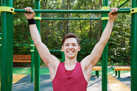 Young man doing fitness exercise on the playground