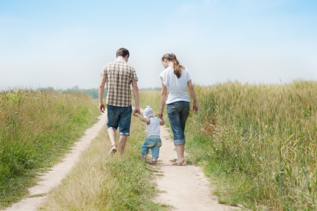 Happy family go in the meadowの写真素材