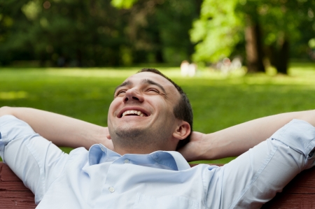 Man sits on bench in the parkの写真素材