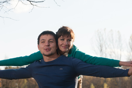 Portrait of young woman and man in the autumn Parkの写真素材