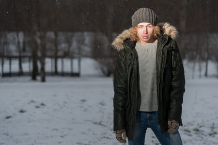 Portrait of young smiling man in the Park at winter