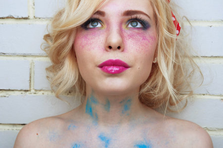 Bright colorful creative make-up on woman face with powder on skin. Retro style.