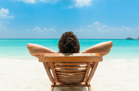 Man relaxing on beach, ocean view, Maldives islandの写真素材