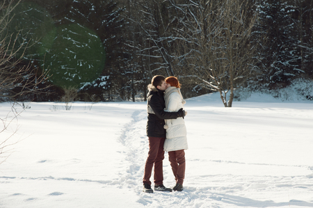 Happy young couple stay in winter parkの写真素材