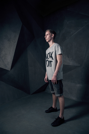 Stylish man looking away, studio fashoin portrait against abstract backgroundの写真素材
