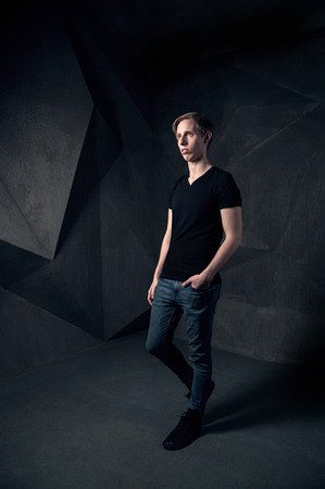 Stylish man looking away, studio fashoin portrait against abstract backgroundの写真素材