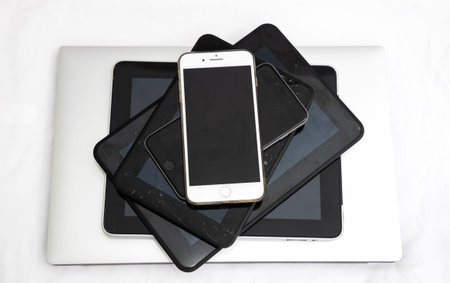 Electronic devices with cracked screens ready for recycling.