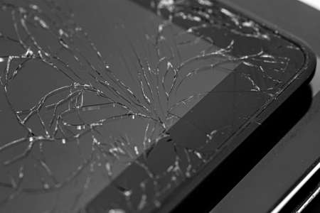 Electronic devices with cracked screens ready for recycling.の写真素材