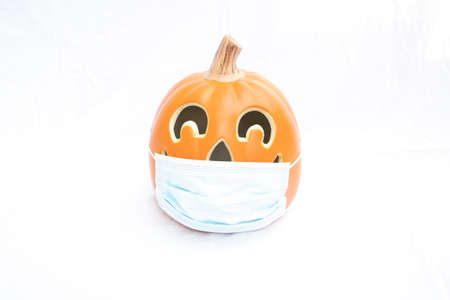 Covid 19 halloween pumpkin with a face maskの写真素材