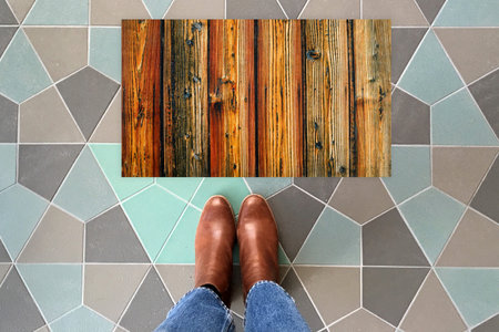 Designer Welcome Entry Doormat Placed on Colorful Tiles Floor with Brown Shoes