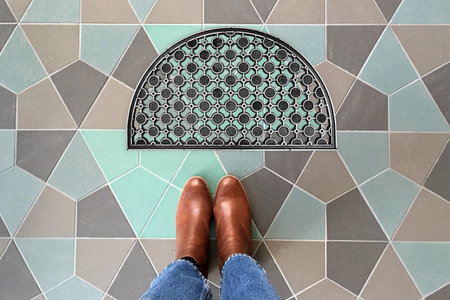 Designer Welcome Entry Doormat Placed on Colorful Tiles Floor with Brown Shoes