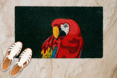 Designer Welcome Entry Doormat Placed on Marble Floor with White Ladies Sandlesの写真素材