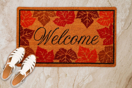 Designer Welcome Entry Doormat Placed on Marble Floor with White Ladies Sandles