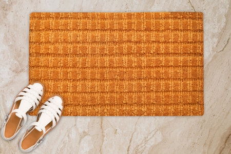 Designer Welcome Entry Doormat Placed on Marble Floor with White Ladies Sandlesの写真素材