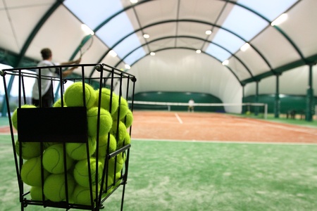 Tennis balls on the indoor tennis court.の写真素材