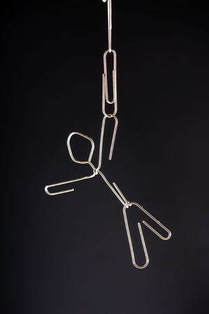 A paper clip man hangingの写真素材