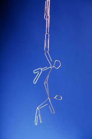 A paper clip man hangingの写真素材