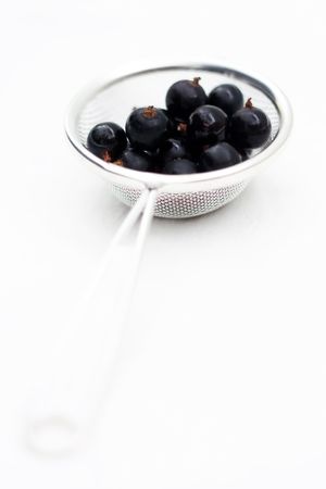 fresh berries in a sieveの写真素材