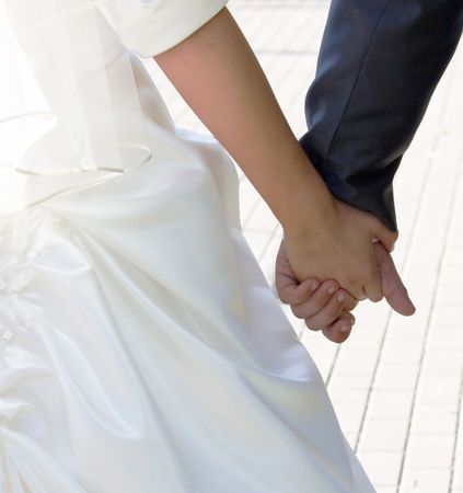   Newlywed couple holding hands の写真素材