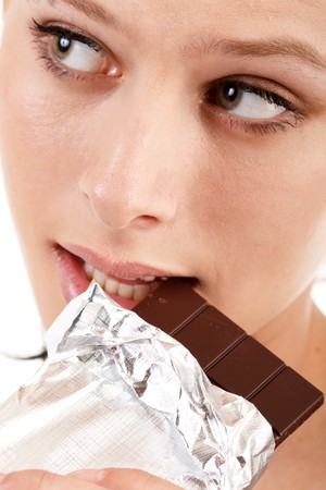 woman eating chocolate の写真素材