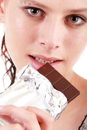 woman eating chocolate の写真素材