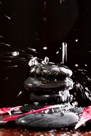 zen stones with water drops and petalsの写真素材